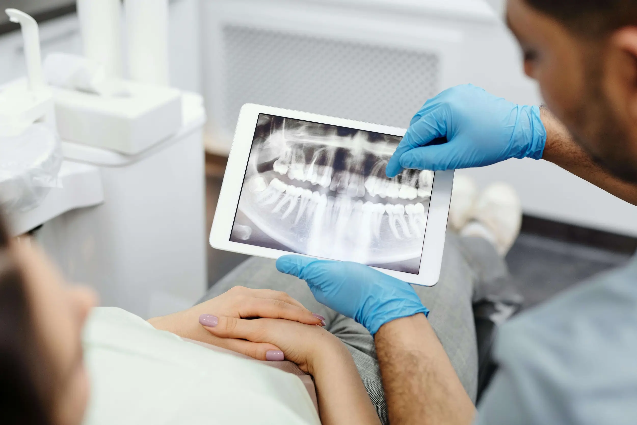 Dentist showing an X-Ray to a patient in a dental clinic