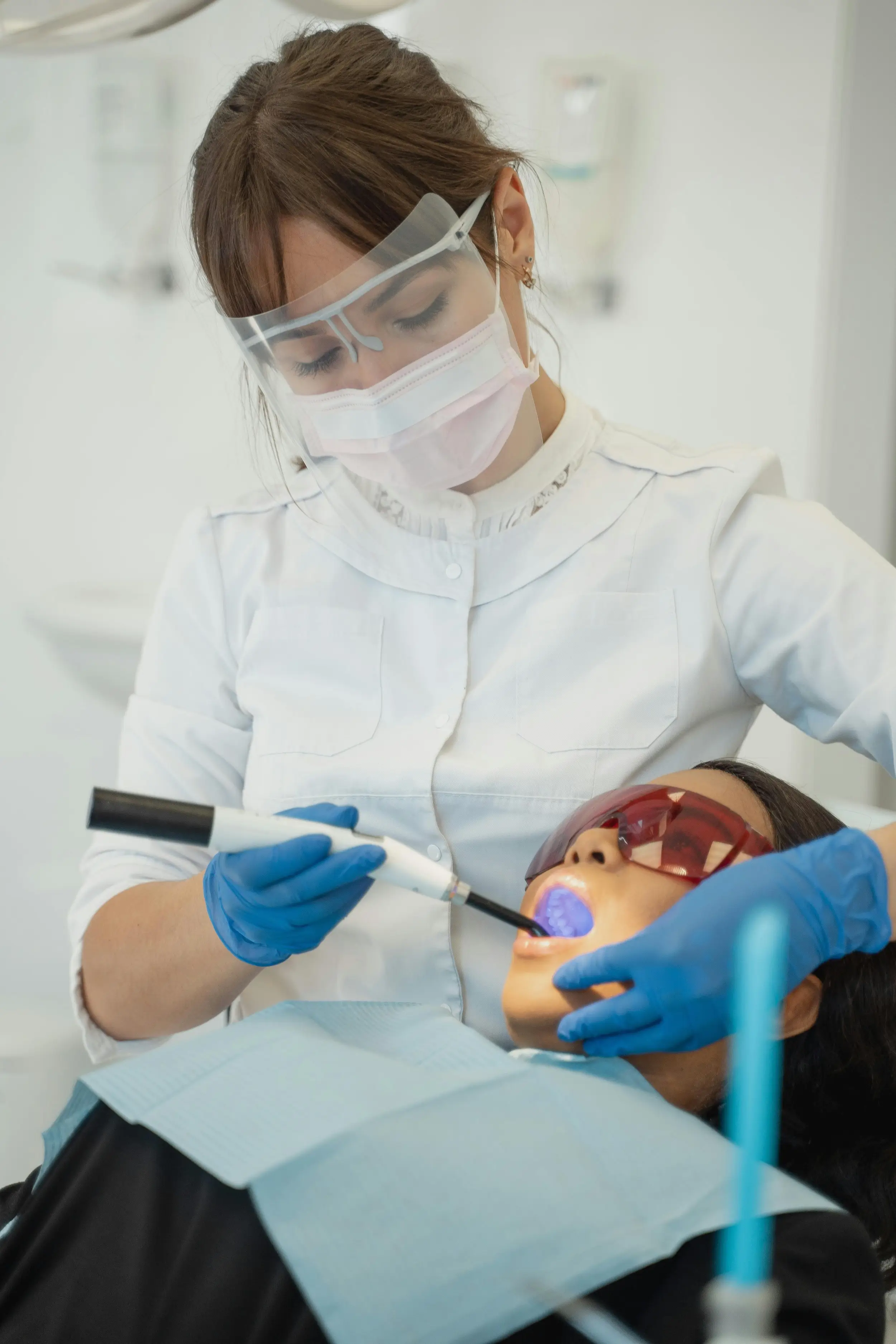 Female Dentist treating a patient in a dental clinic